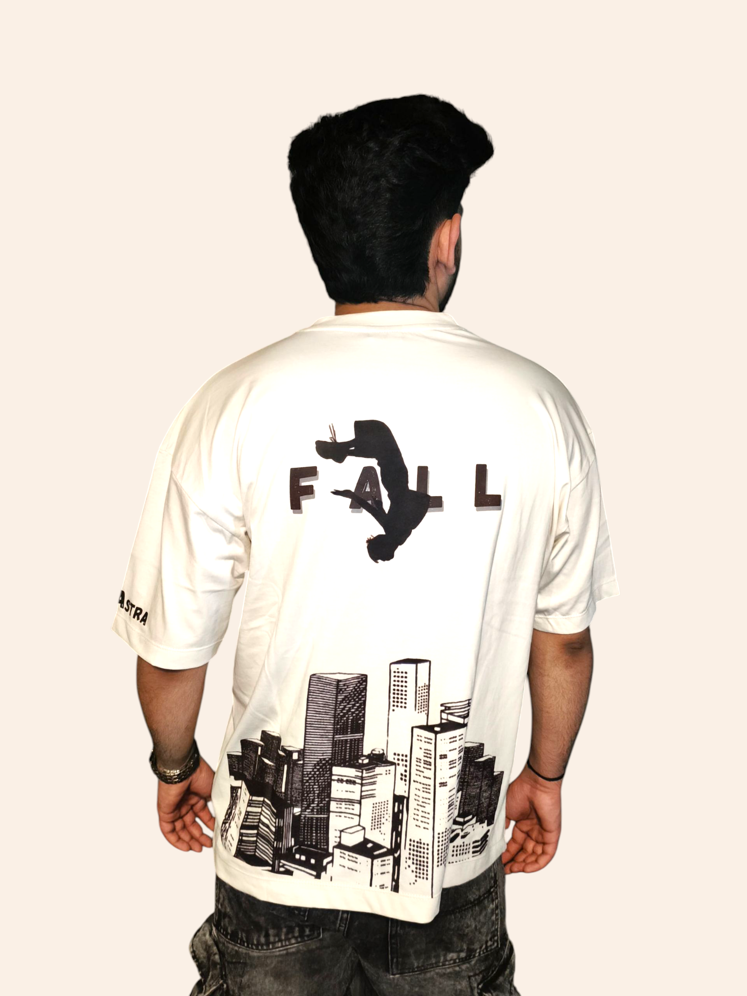 Person wearing a white VeerAstra t-shirt with a graphic design on the back, standing against a plain background.