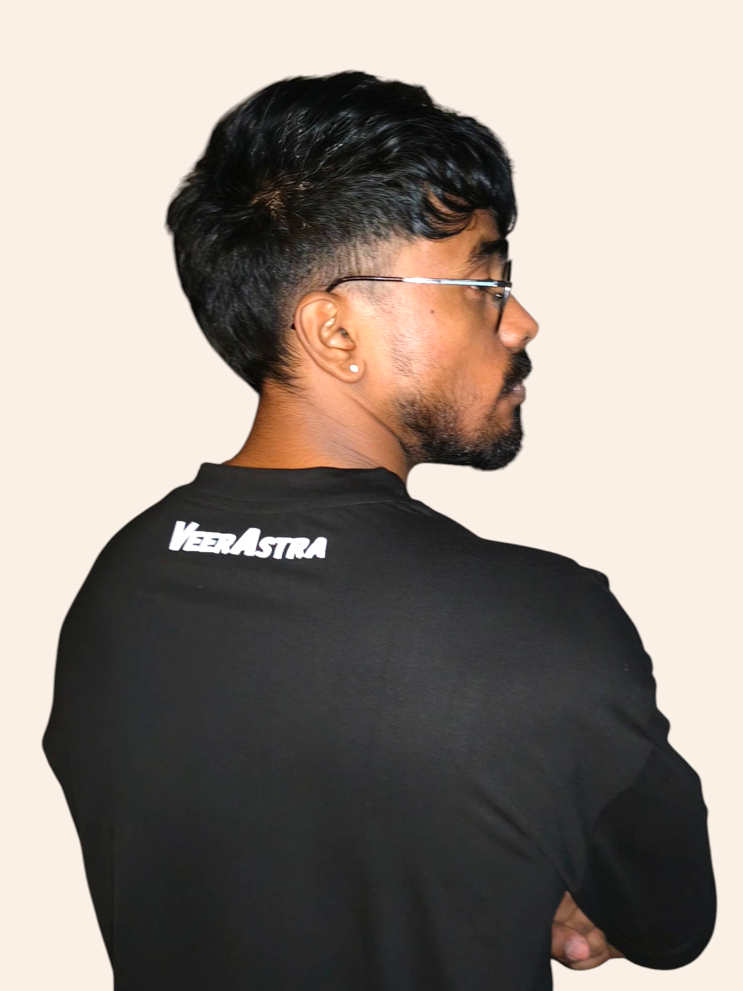 Man wearing a VeerAstra black t-shirt with 'VeeraAstra' logo on the back against a plain background