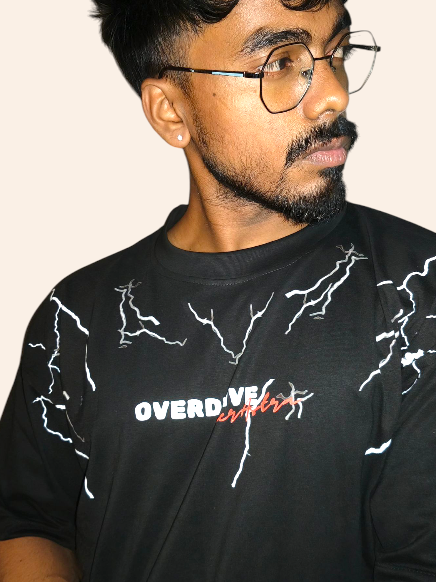 Man wearing a VeerAstra black t-shirt with white graphics and text