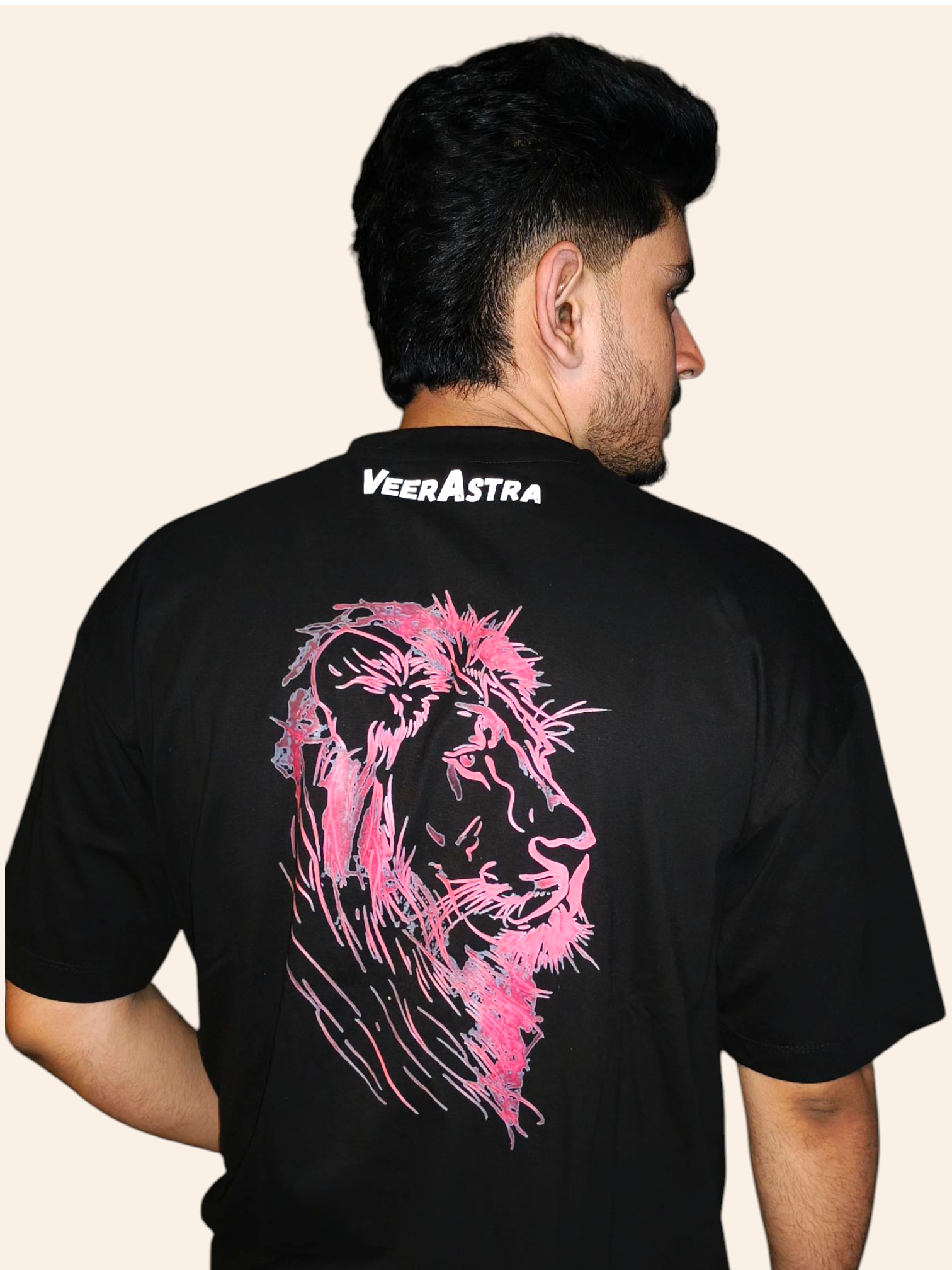 Man wearing a black t-shirt with pink lion design and 'VeeraAstra' branding on the back.