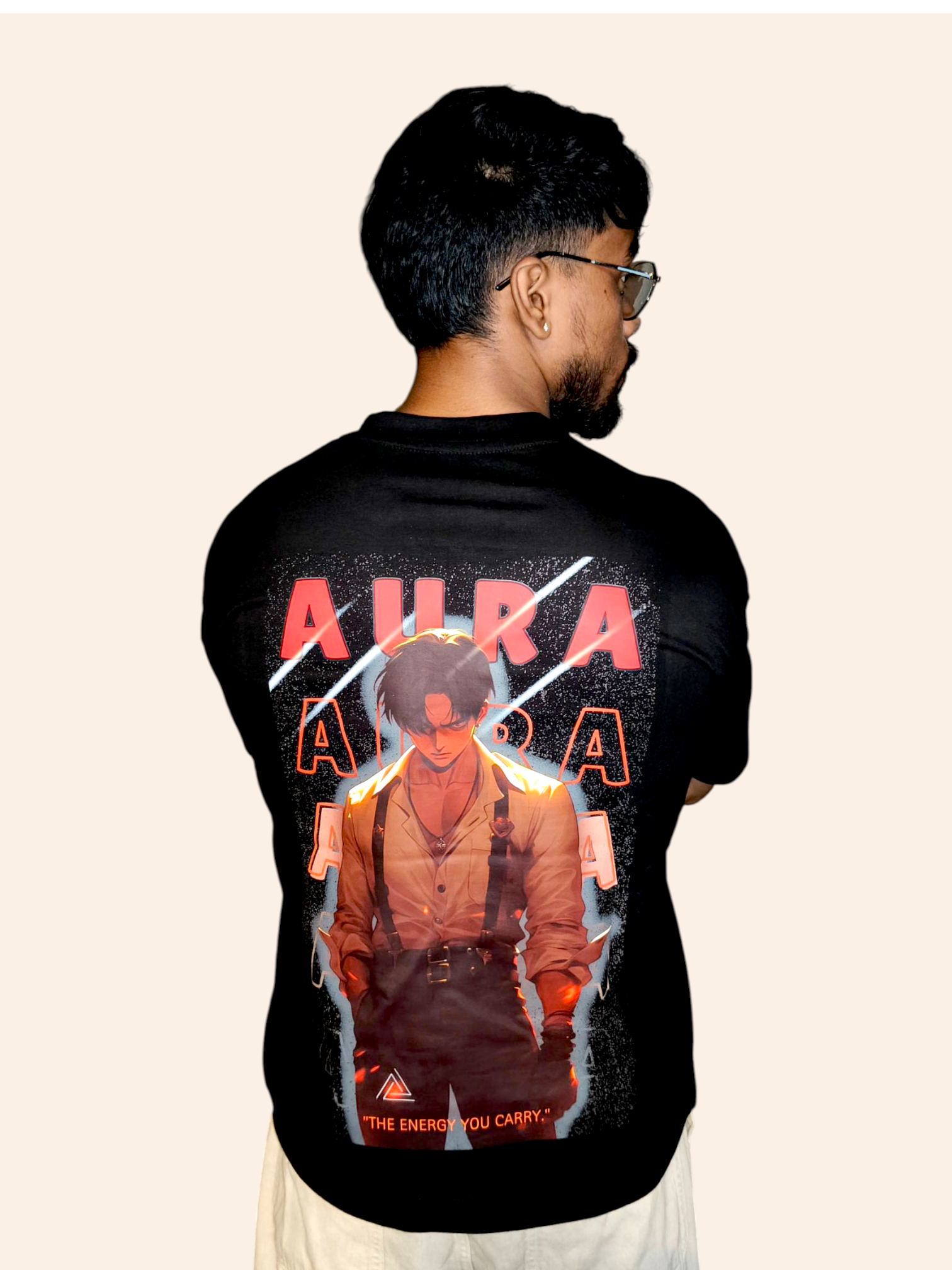 Person wearing a VeerAstra black t-shirt with a graphic design on the back, featuring the word 'Aura' and an illustration of a person.