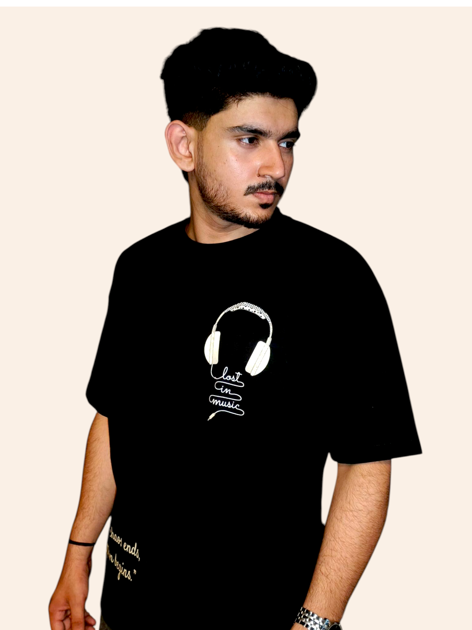 Person wearing a VeerAstra black t-shirt with a white graphic design on a beige background