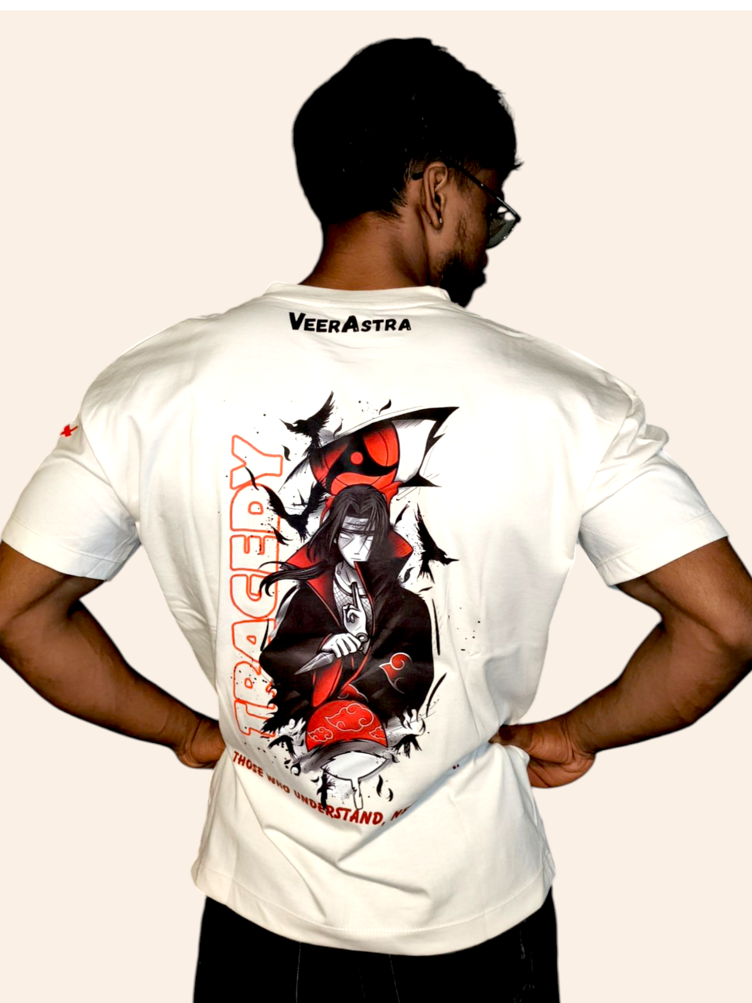 Person wearing a VeerAstra off-white t-shirt with a graphic design on the back, standing against a plain background.