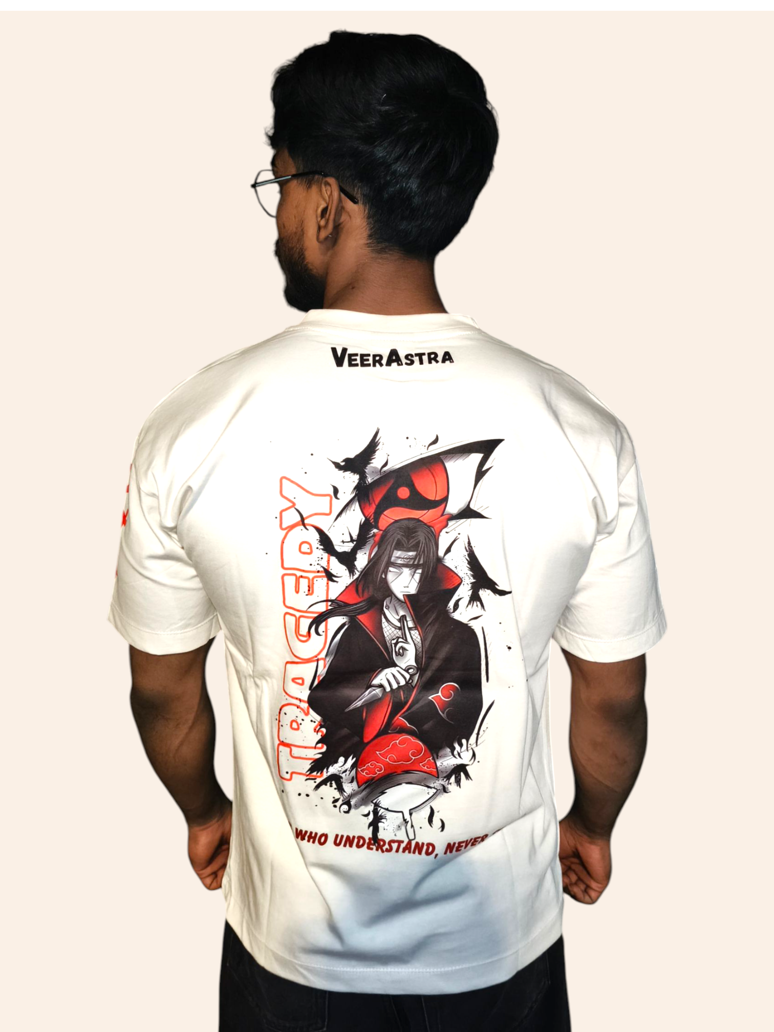 Person wearing a VeerAstra off-white t-shirt with a graphic design and text on the back, on a plain background.