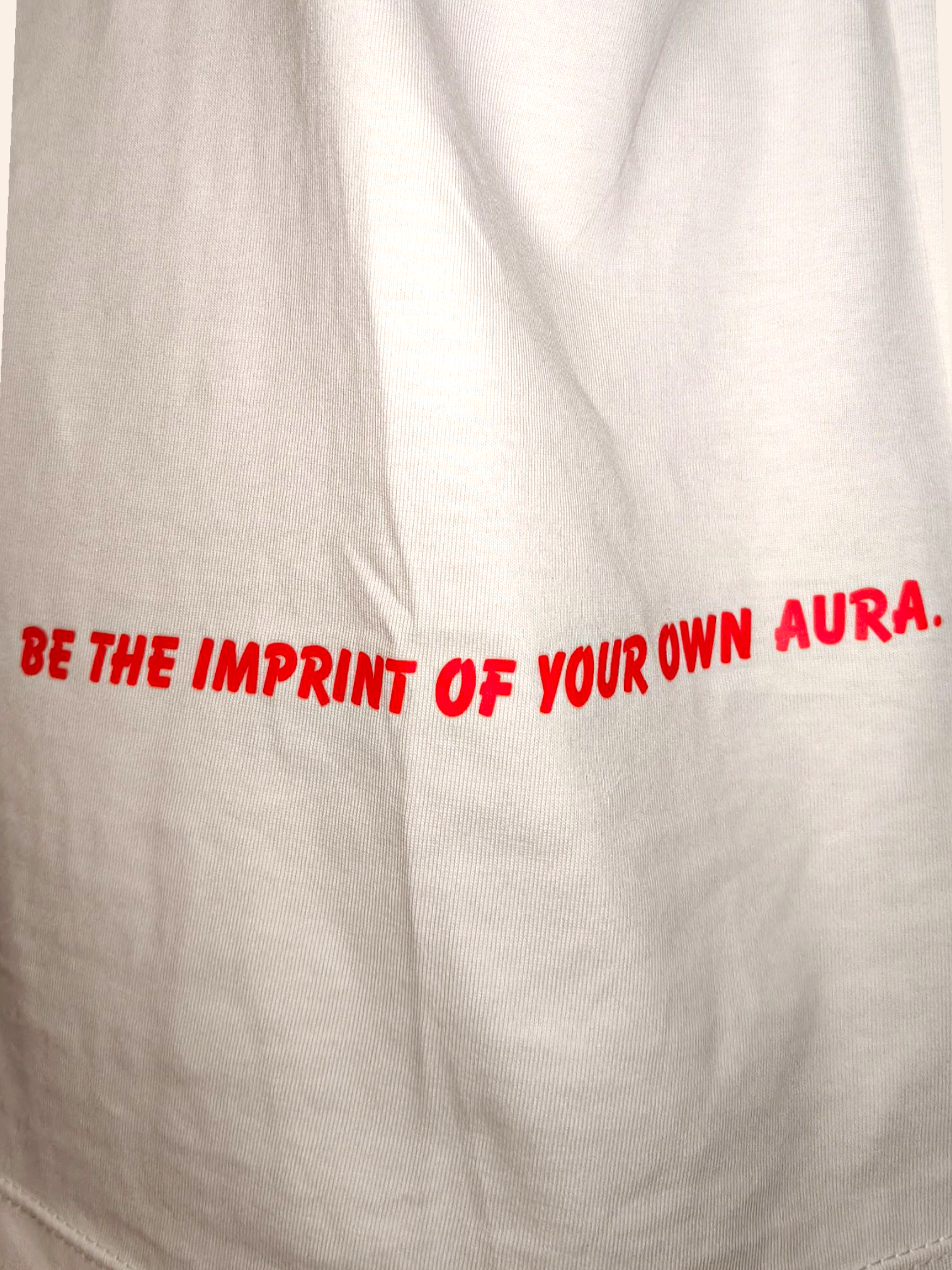 Text 'BE THE IMPRINT OF YOUR OWN AURA.' on a beige background