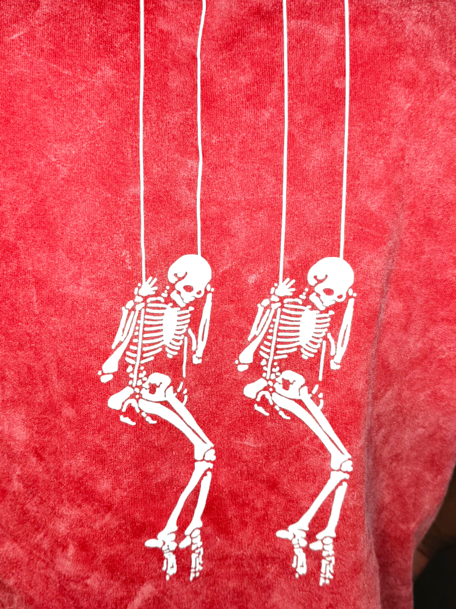 VeerAstra Red acid wash tshirt back print White skeletons on a red textured background