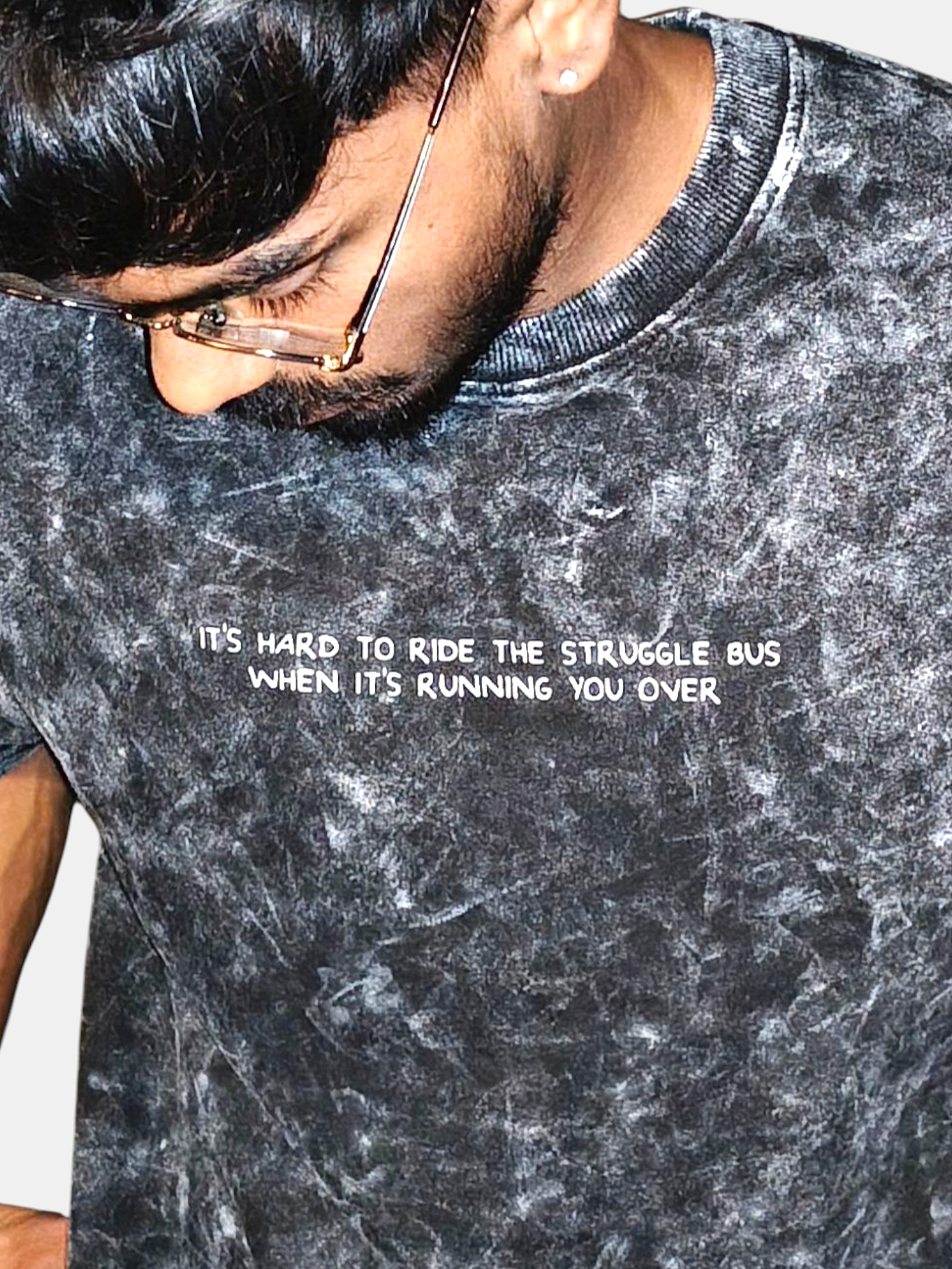 Person wearing a VeerAstra gray t-shirt with a printed quote on a plain background